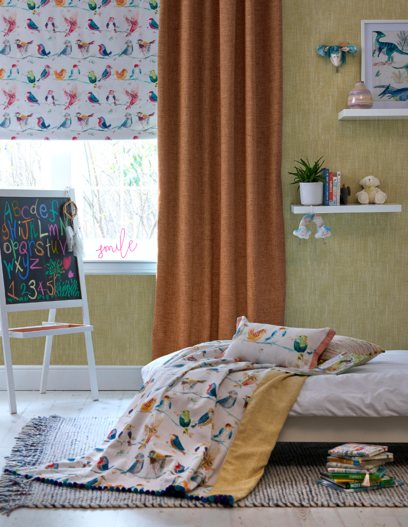  A playfully designed child's bed room with kids blinds and orange curtains.