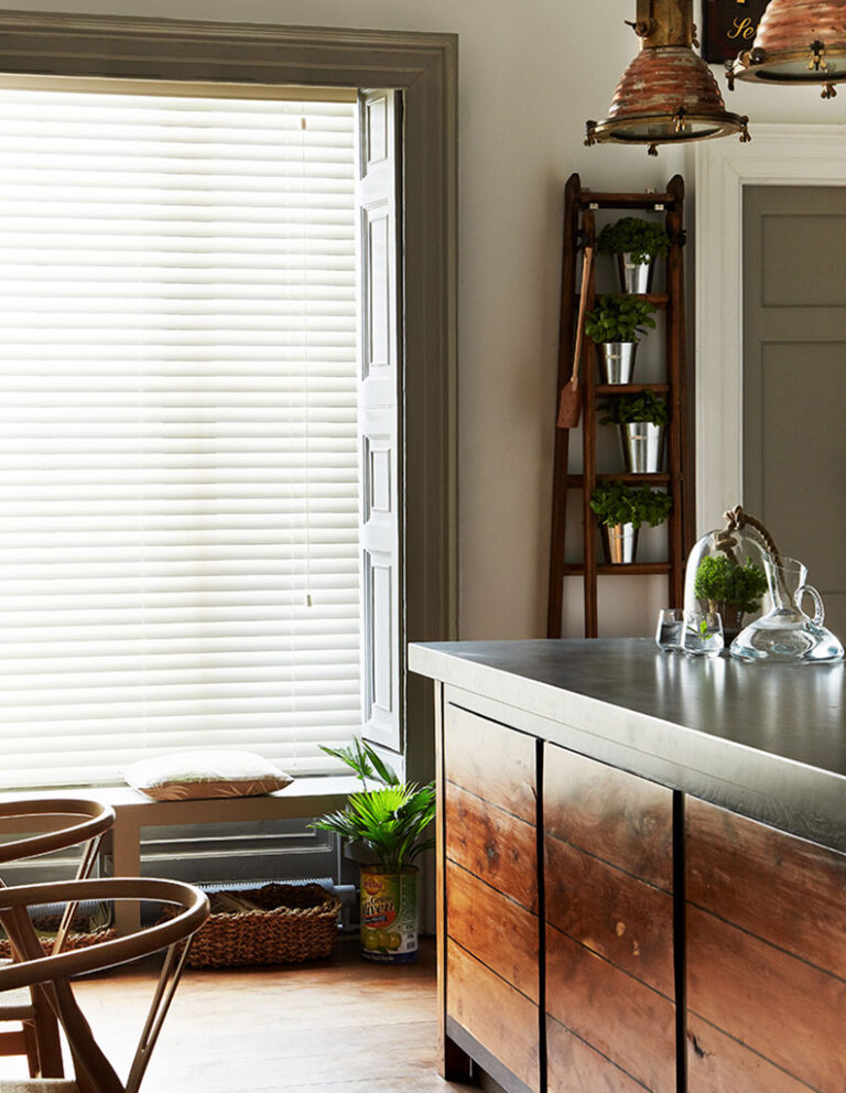 Venetian blinds in a dark-wood kitchen. 