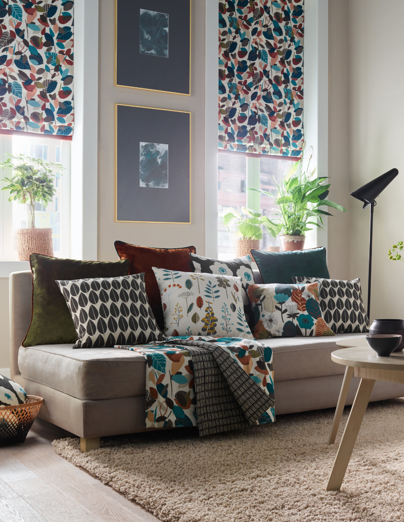 A patterned living room featuring colourful blinds and cushions. 