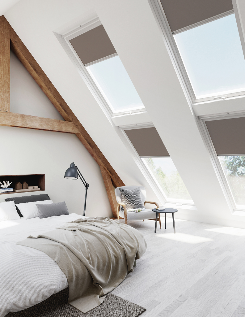 A bed room featuring skylights with blinds. 