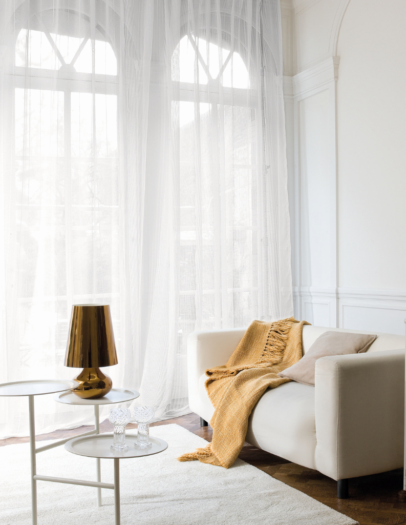 Bright white voiles in a minimalist sitting room. 