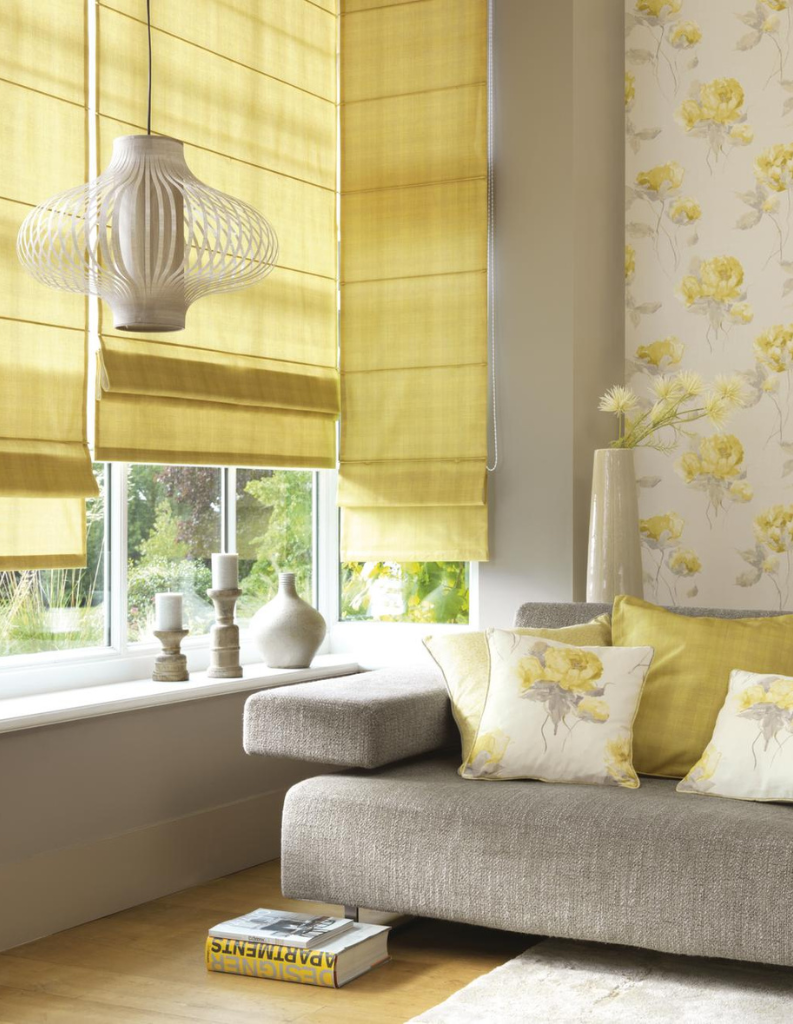 Energising butter yellow roman blinds with matching cushions in a modern living room.