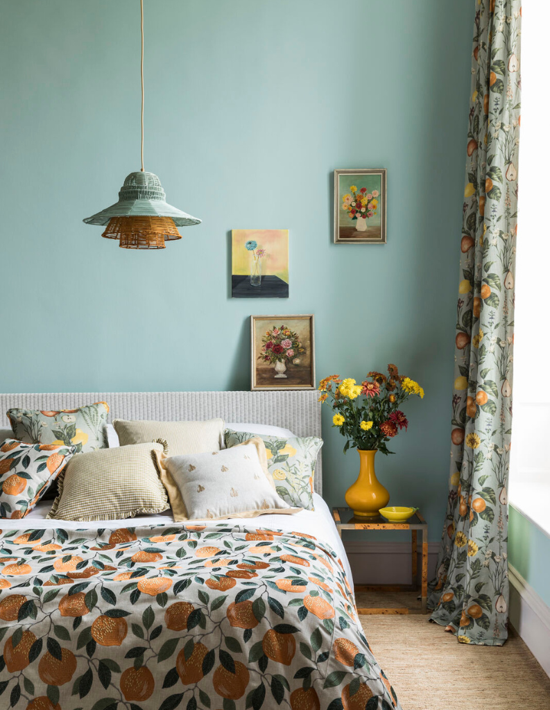 Jelly mint walls in a bedroom with floral bedding and curtains.