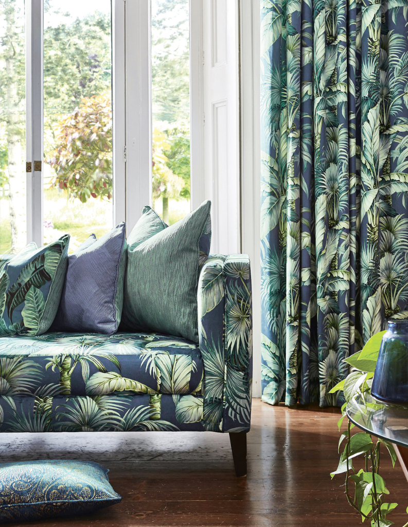 Tropical patterned curtains with floral sofa and colour cushions.