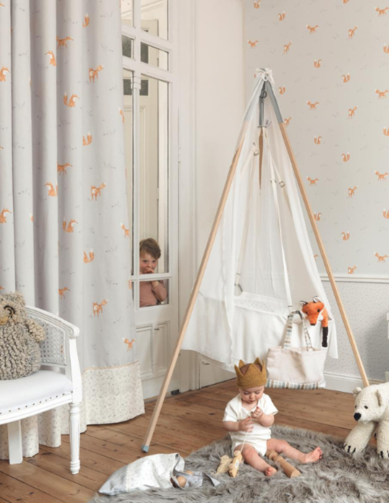 A baby's place space featuring fun curtains and toys.