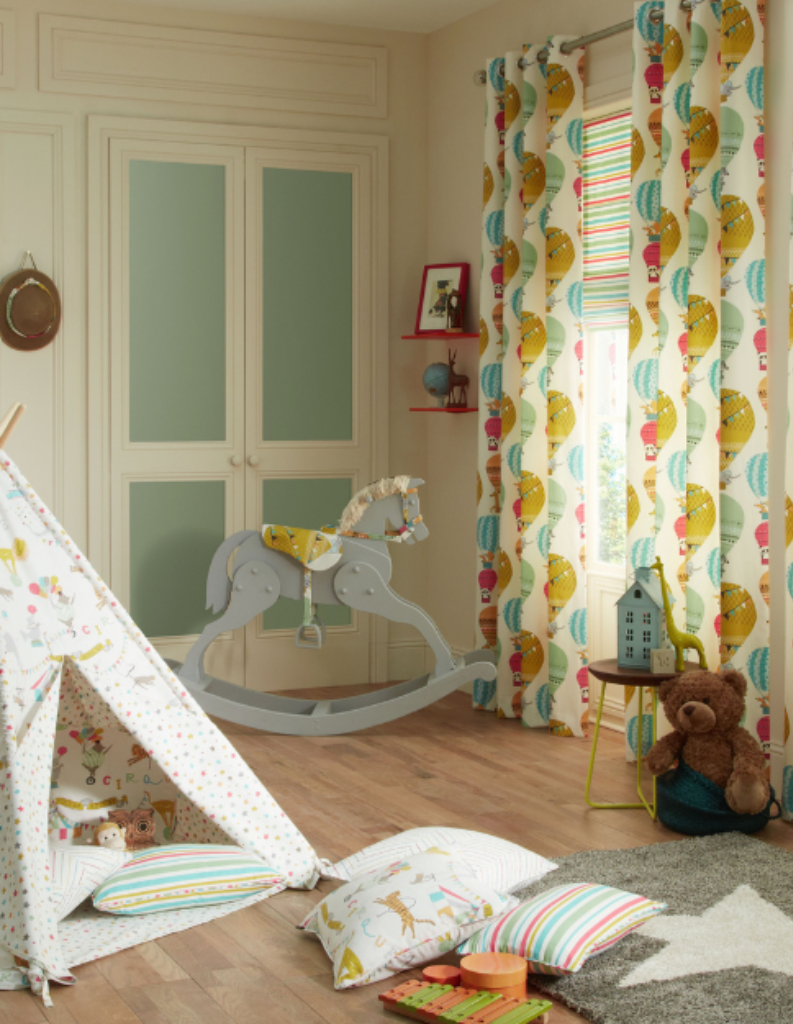 A fun, colourful kids room with toys and curtains for children.