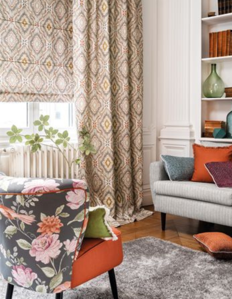 A bright living room featuring matching Roman blinds and curtains in the window.