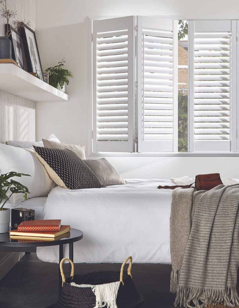 A fashionable bed room with shutters