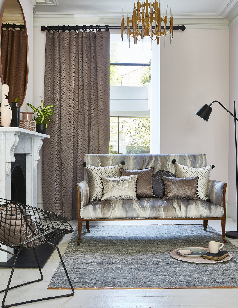 Stone shades in a living room with grey curtains and marble inspired furniture.