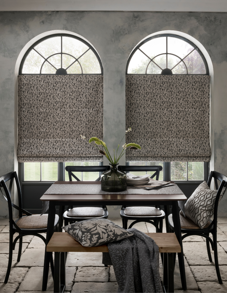 Stone colours in a beautiful dining area. The image features stone inspired Roman blinds in the window.