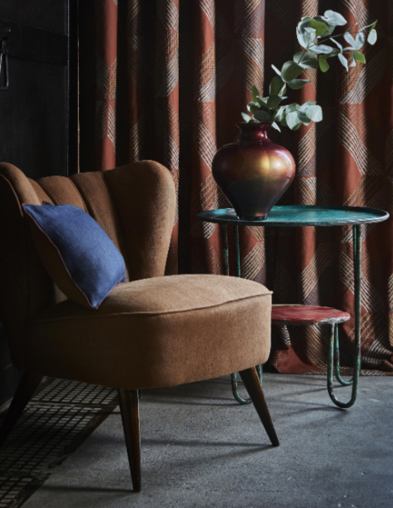 an art deco living room with chair and curtains