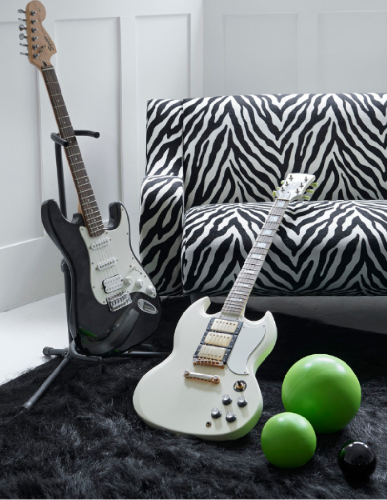 An 80s post modern living room with zebra print sofa and guitars.